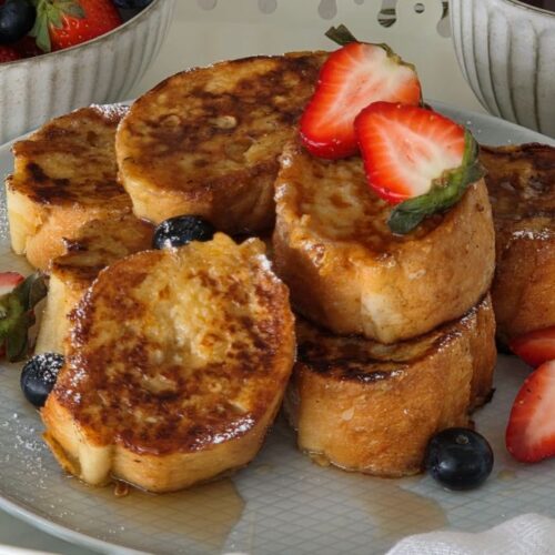 Mini French Toast Bites made with baguette, served with maple syrup and fresh berries