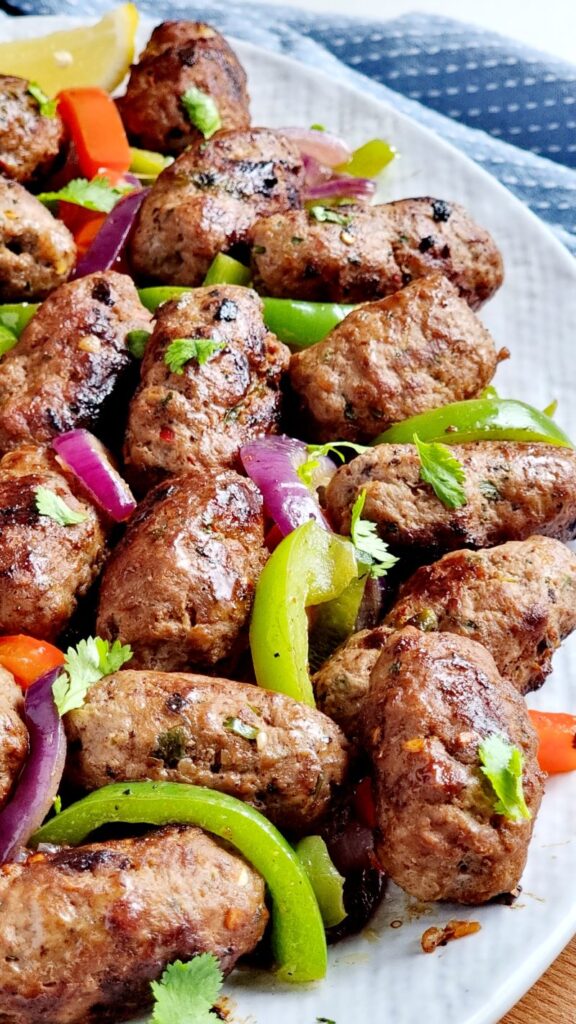 Close-up of juicy Pakistani Gola Kebabs shaped into oval form
