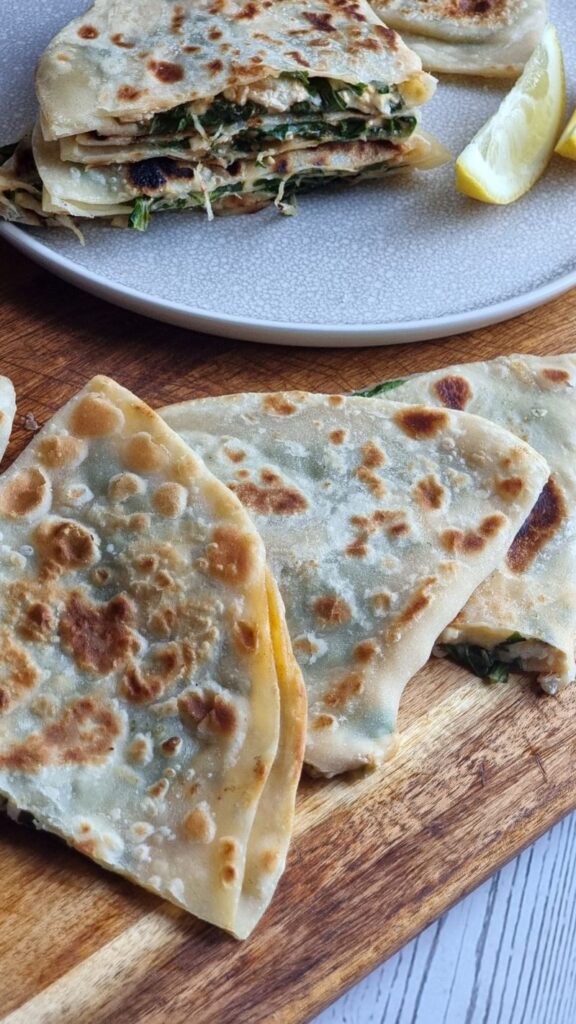 Golden crispy spinach and cheese gozleme sliced