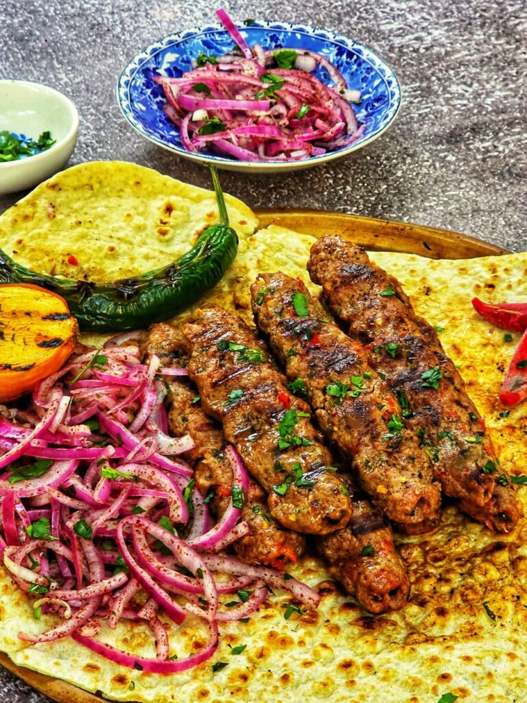 Turkish Adana Kebabs served with Lavash bread and onions sumac salad