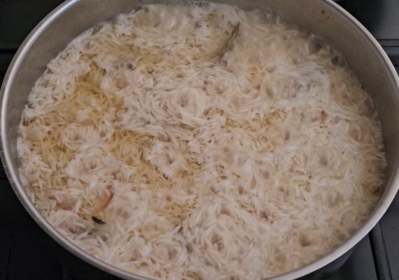 Rice cooking in meat broth for Afghan pulao