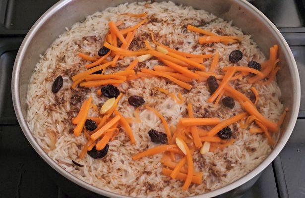 Basmati rice ready for steaming with lamb broth and char masala for Afghan Pulao