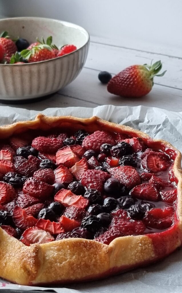 Side view of rustic mixed berry galette