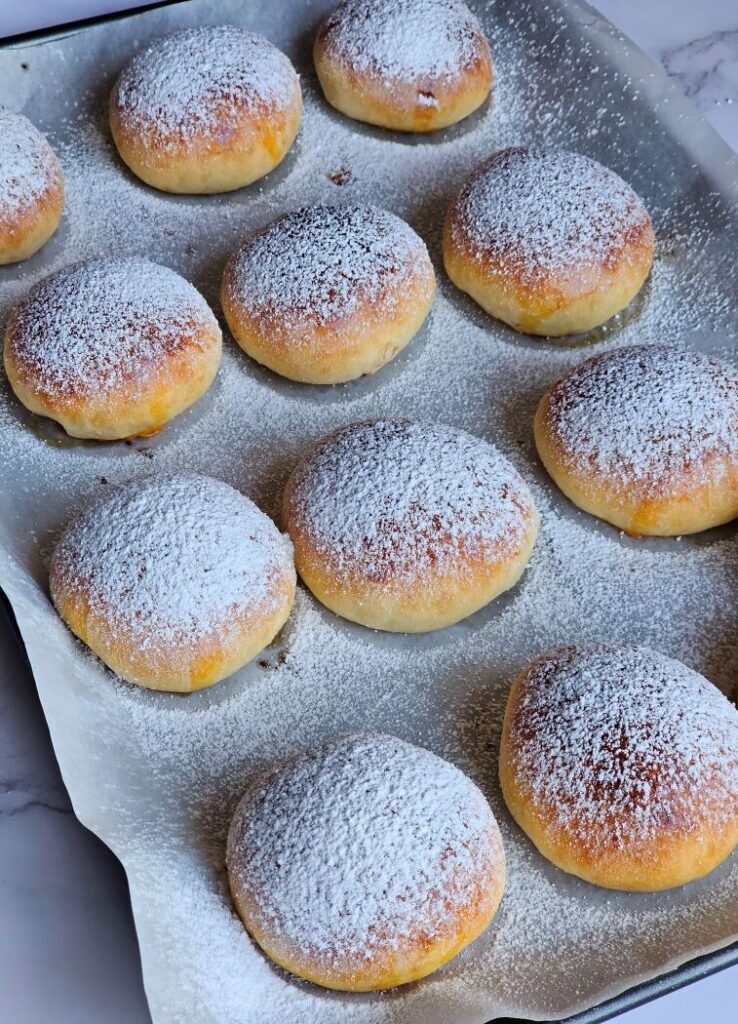 Freshly baked Nutella Bombs on baking tray with golden crust and soft centers