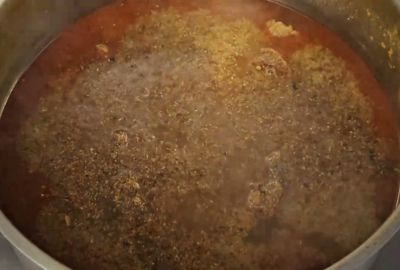 Homemade Nihari masala being mixed into the cooking stew