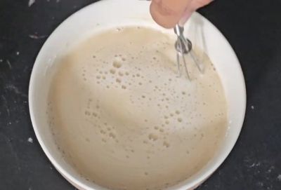 Whisking whole wheat flour (atta) with water to make slurry for Nihari gravy