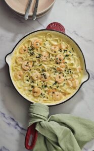 Hero Image creamy garlic prawn pasta in a skillet