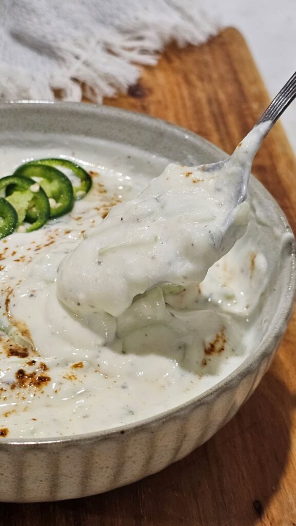 Pouring Cucumber raita with spoon